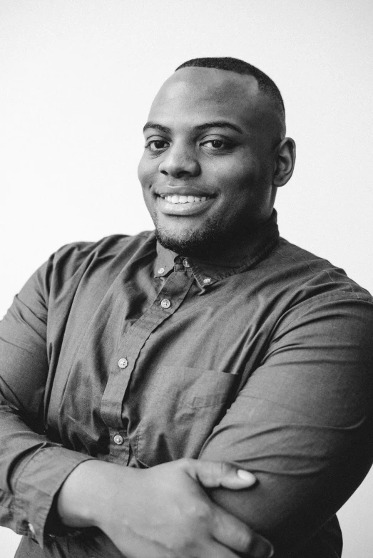 man standing with hands folded with arms crossed