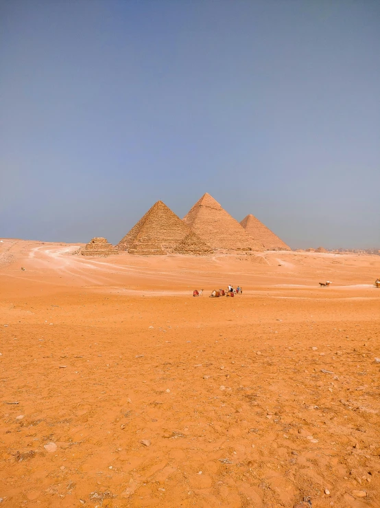 some very big brown pyramids in a desert