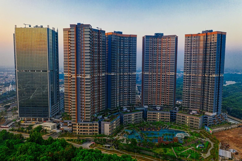 a view of several tall buildings near a park