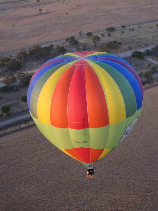 a  air balloon is flying over the desert