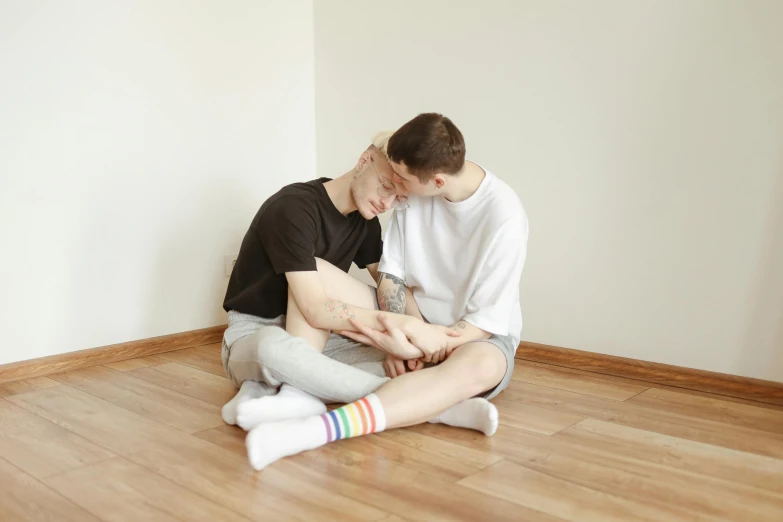 a woman in high waisted tights hugging a man in a black t - shirt