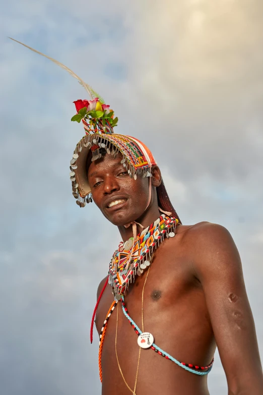 a man with colorful beads is posing