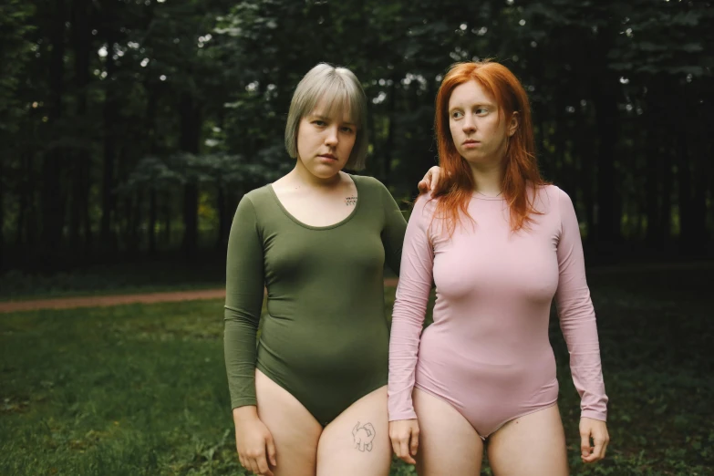 two women with red hair and one is holding her hands on her hip