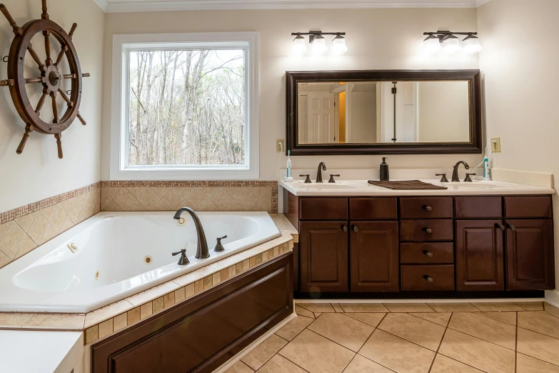 this bathroom has a large tub and two sinks