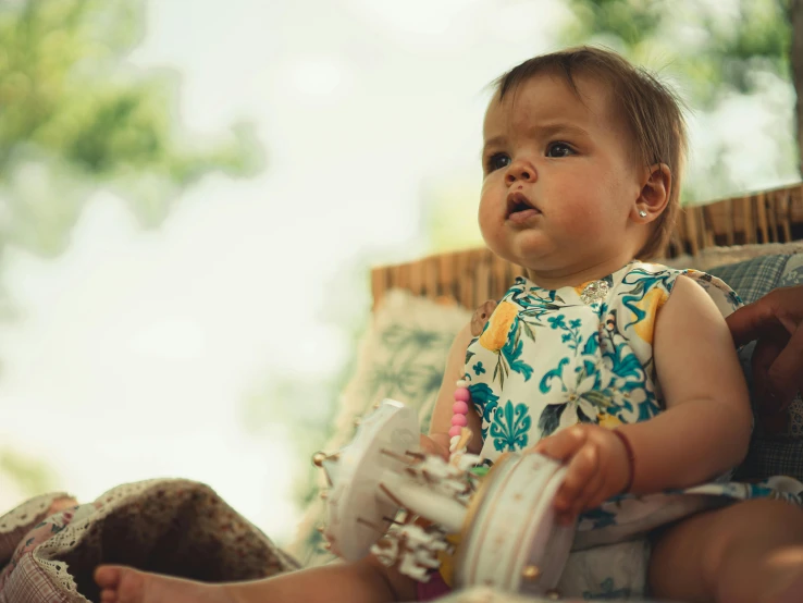 a small child sitting on a couch looking away