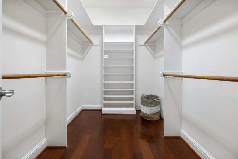 a white closet with some shelves on the wall