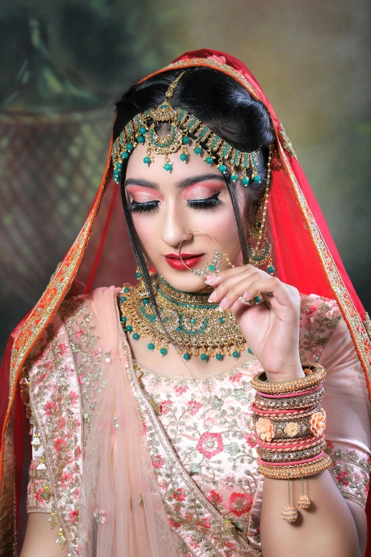 a young woman dressed in a bridal outfit is posing for the camera