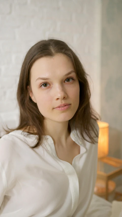 a girl in white posing for the camera