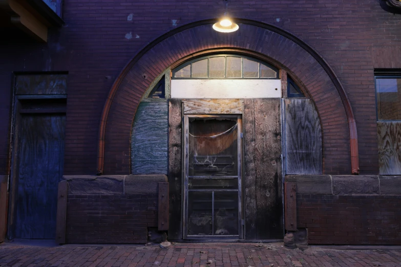 a door is open in front of a brick building