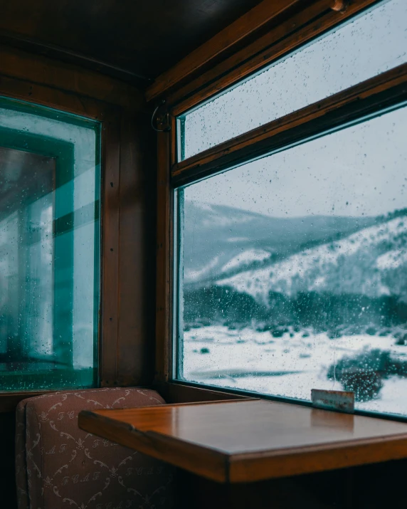 a po taken out a bus window overlooking snow covered mountains