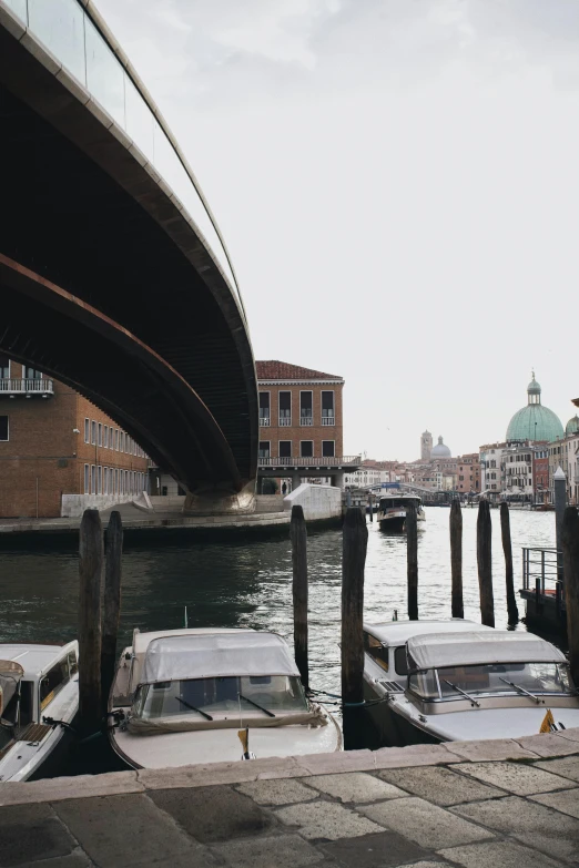 three motor boats parked on the pier at a waterway