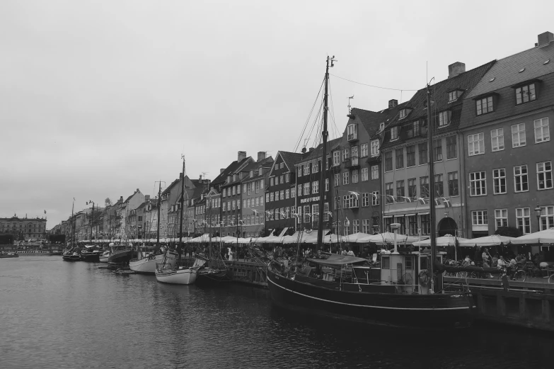 there are many boats parked on the water by the buildings