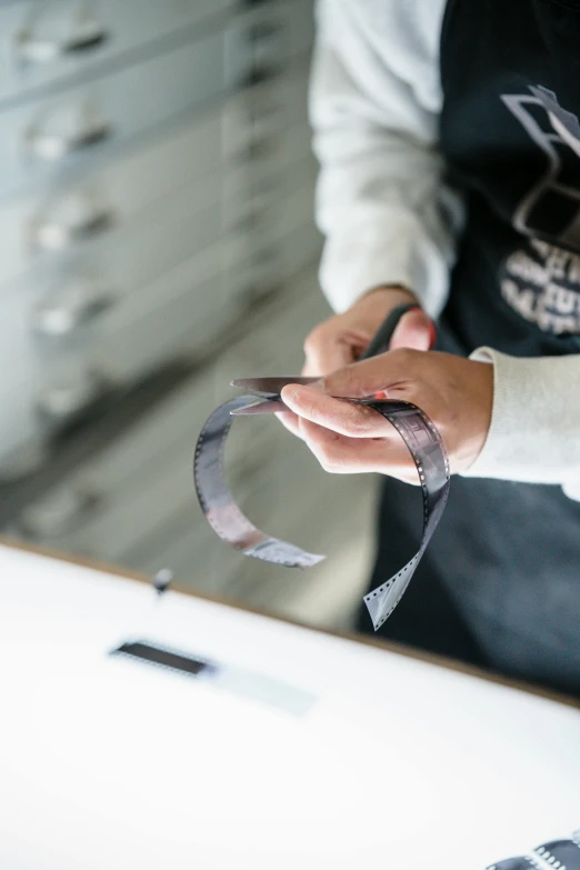 person holding up a ribbon in both hands