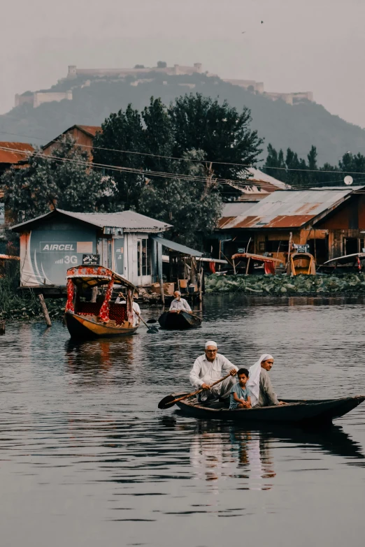 a couple of men in a canoe on a lake