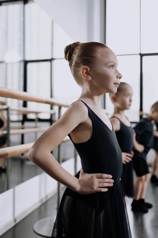 the dancers pose for a group po in a dance studio