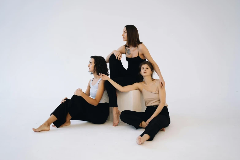 three women sitting side by side on a couch