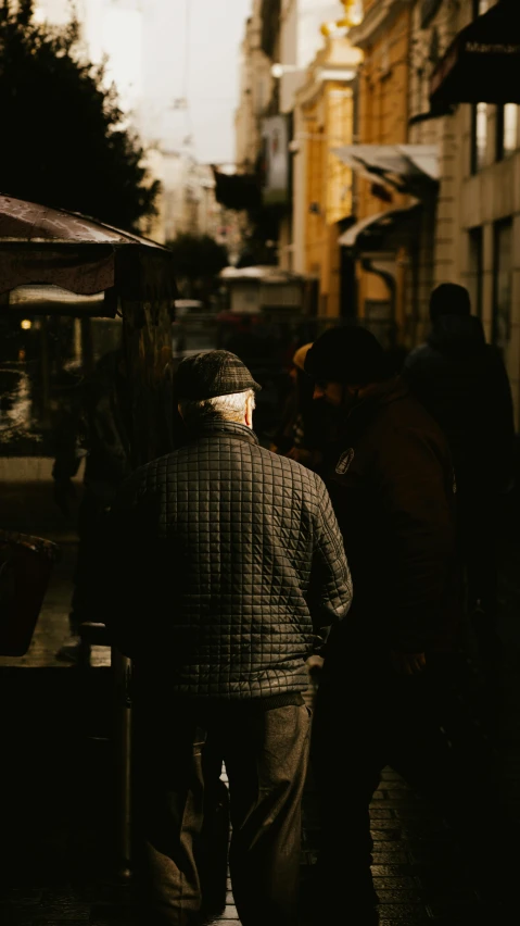 a man is standing alone on a city street