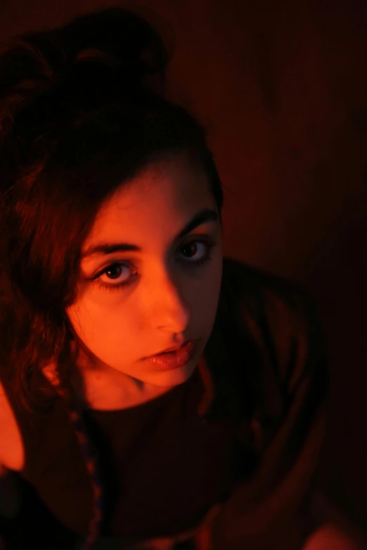 a beautiful young lady in a dark room