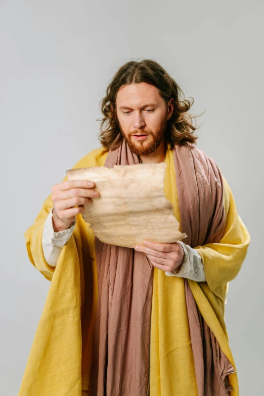 man in long robe and yellow scarf wrapping paper