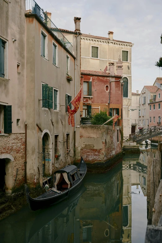 a narrow canal with three boats in it