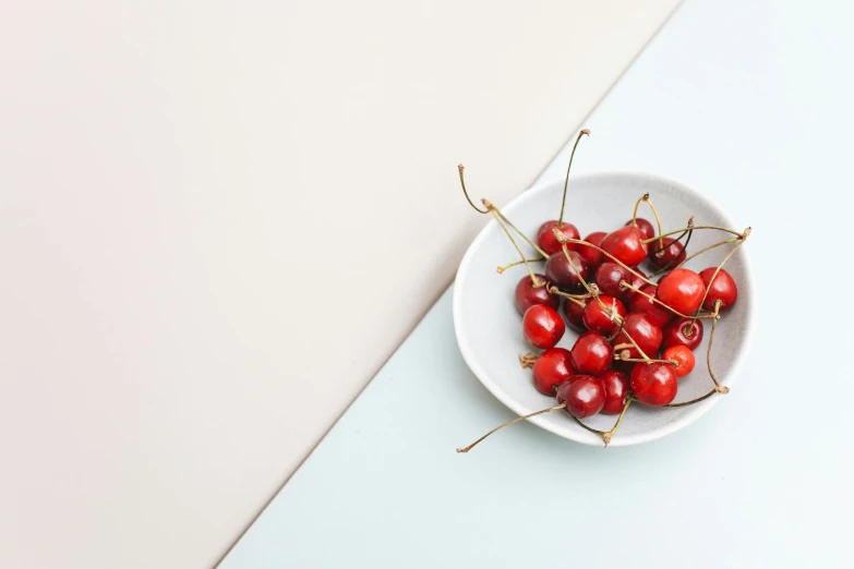 some red berries sitting in a white bowl