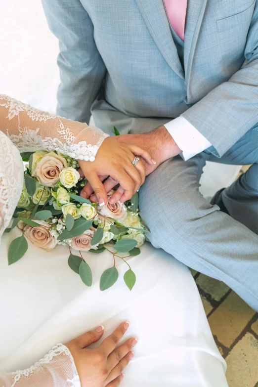 a bride holds the groom's hand during their wedding