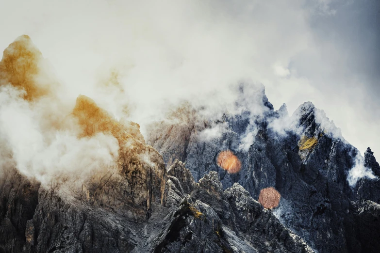 an artistic po of mountains with fog