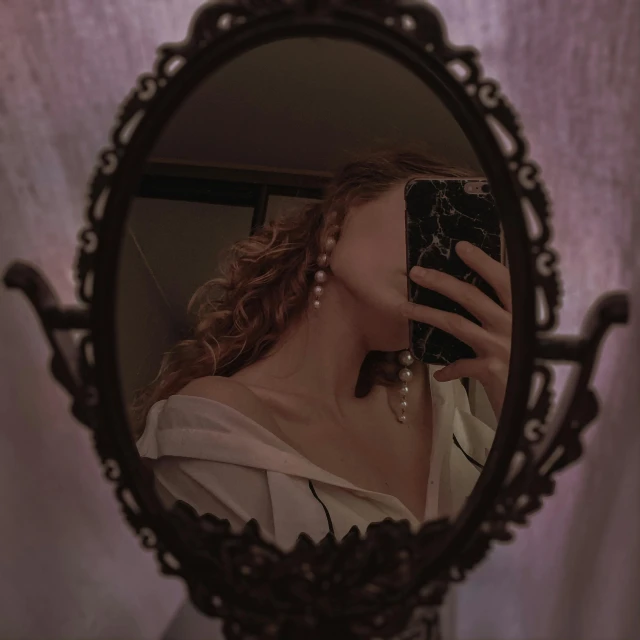 a woman takes her picture in the mirror