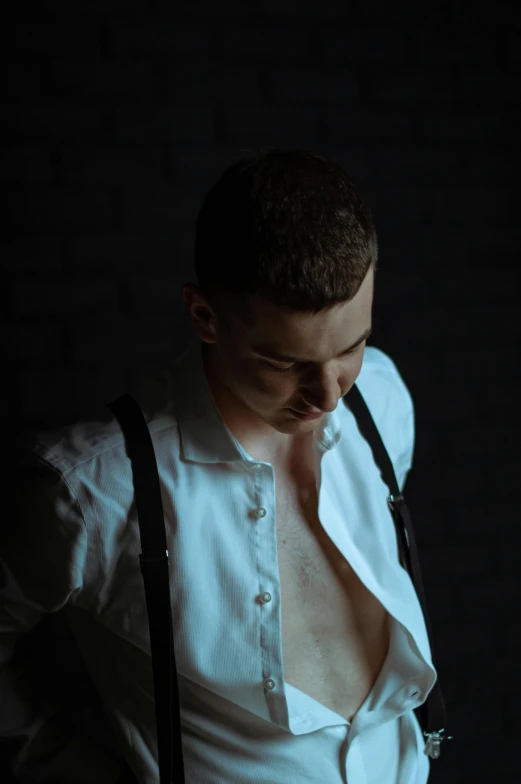 a man wearing suspenders, a shirt, and a tie