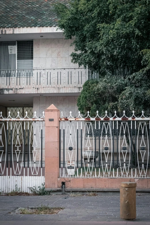 a black fence stands behind an old building