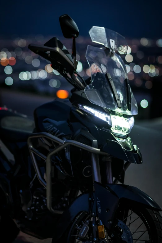 a motorcycle parked on a parking lot in front of the city