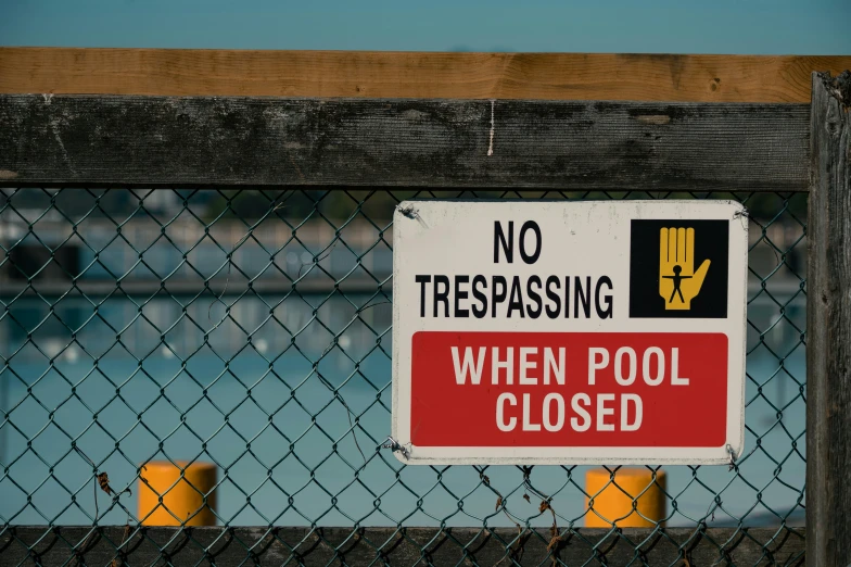 there is a sign behind a fence saying no trespassing