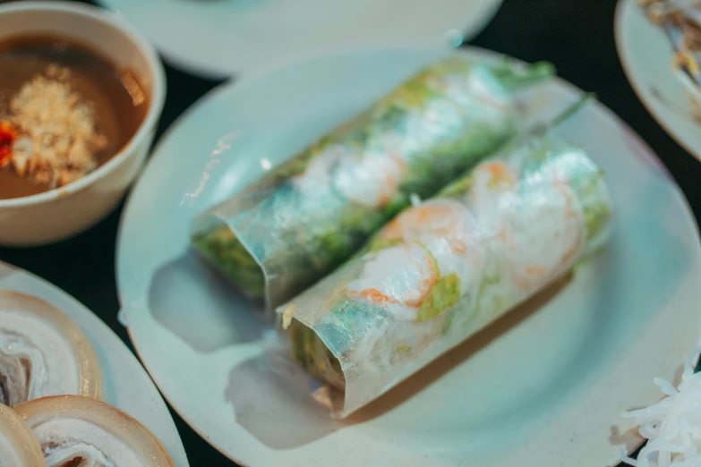 a close up of two vegetable wrapped food items