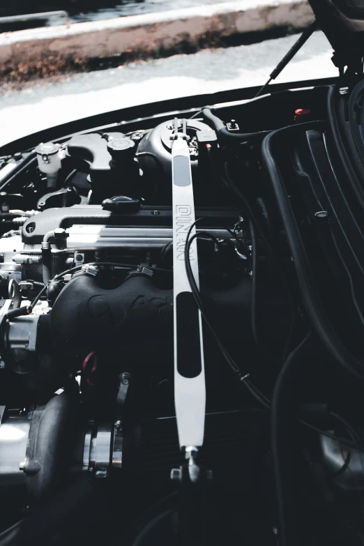 an engine with the hood closed sitting inside of a car