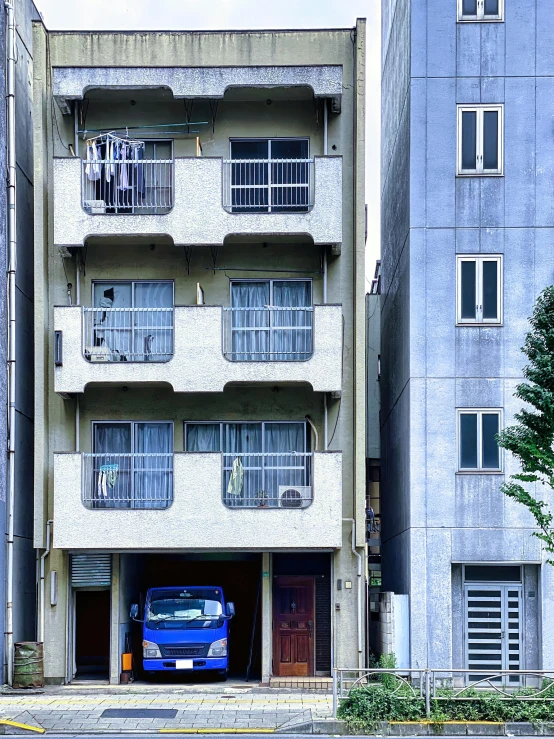 an apartment building with cars parked underneath it