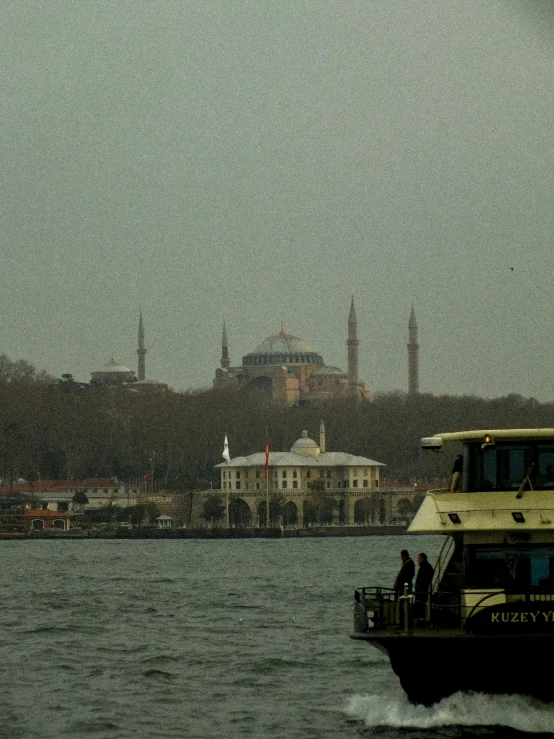 the boat is on the river in front of a castle