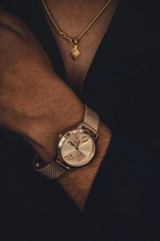 a lady with celets and a watch in hand