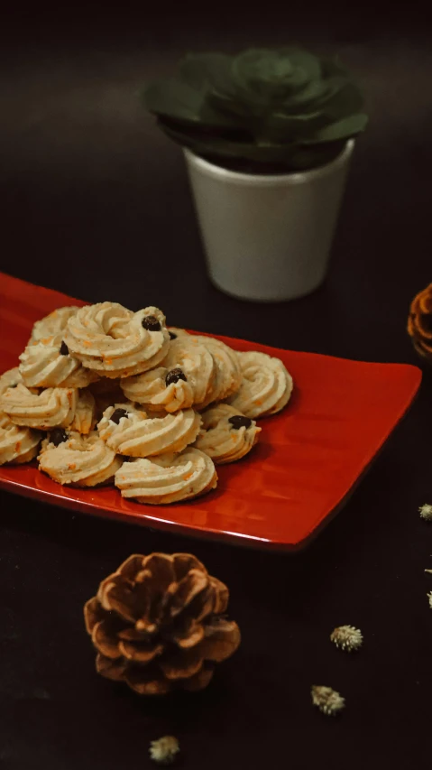 cookies sitting on a plate near some flowers