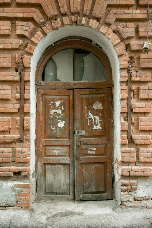 the door to a building with a brick wall