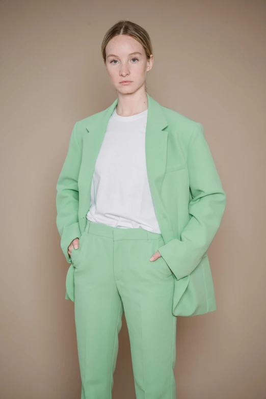 a woman in a light green blazer and trousers