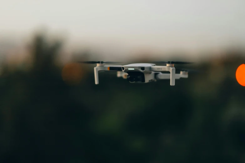 a small white airplane flying through the air