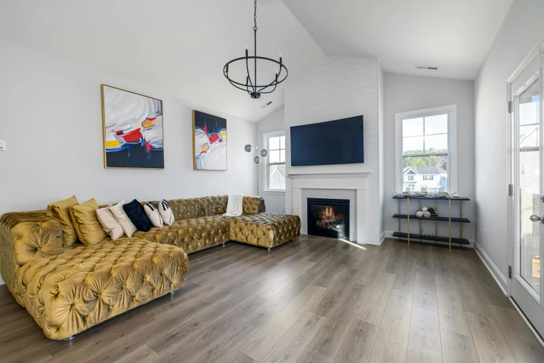 a couch with many pillows in front of a fire place