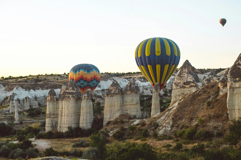 a few colorful balloons flying in the sky