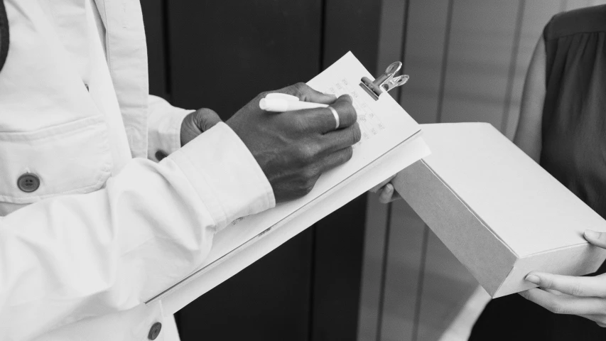 black and white pograph of a person holding a box