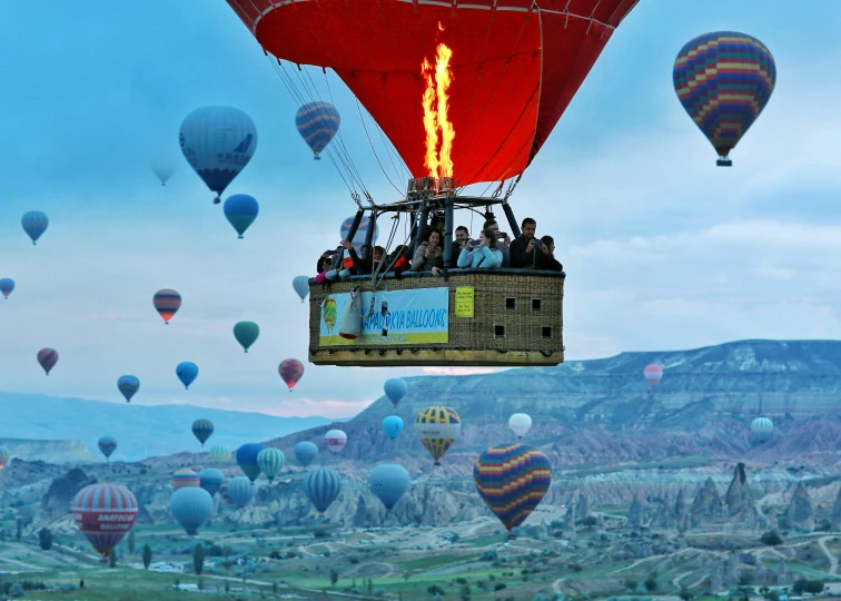 several  air balloons flying over a valley