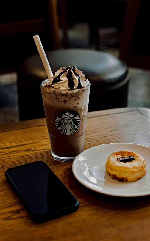 coffee and doughnut with milkshake sit on a plate