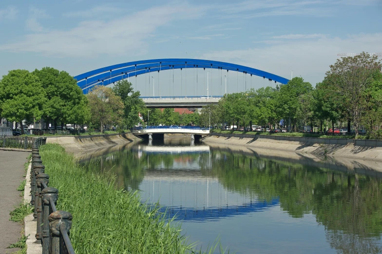 a bridge spanning a river with a bench next to it