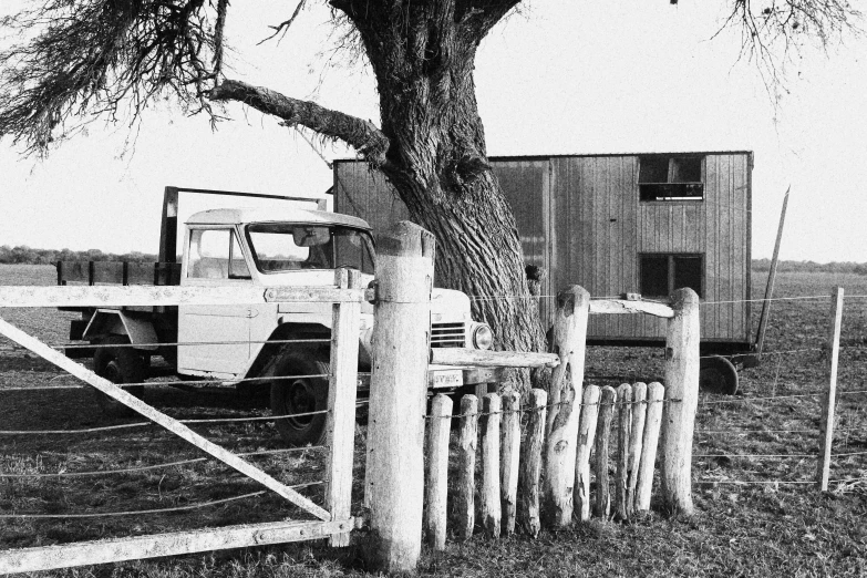 truck by fence in old fashioned black and white po