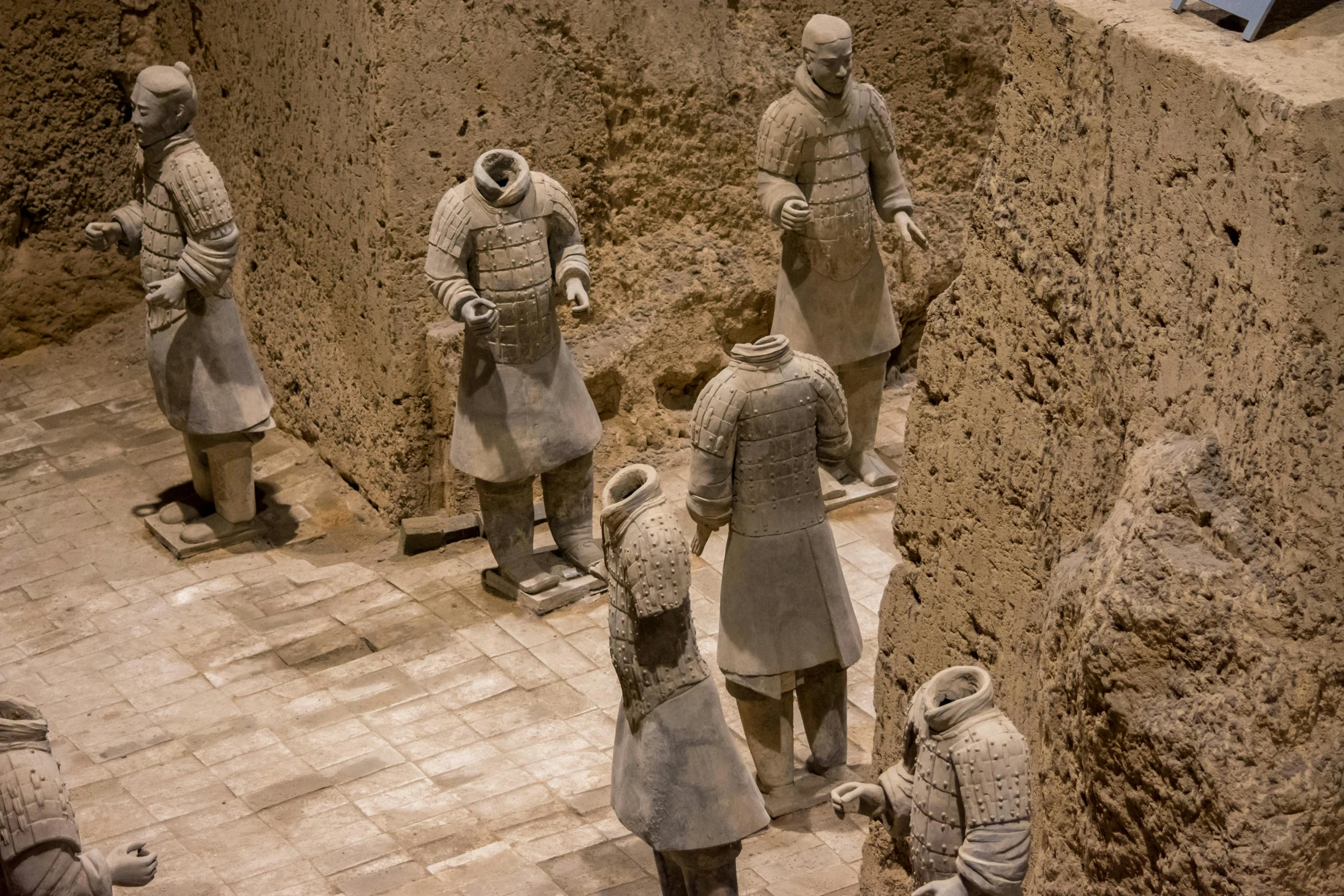 several statues of soldiers standing around in a museum