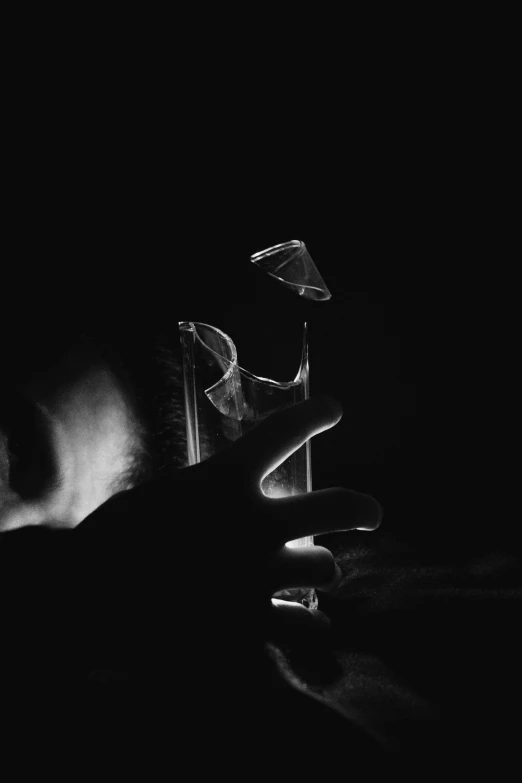 a hand with some glasses on top of a table